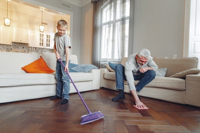Father and son cleaning the floor.