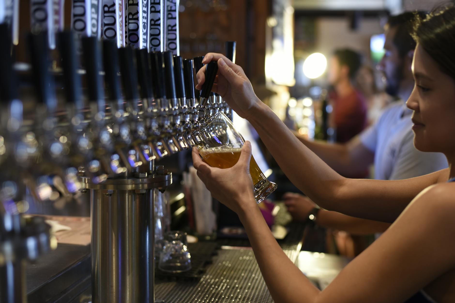 pan holding pilsner inside bar