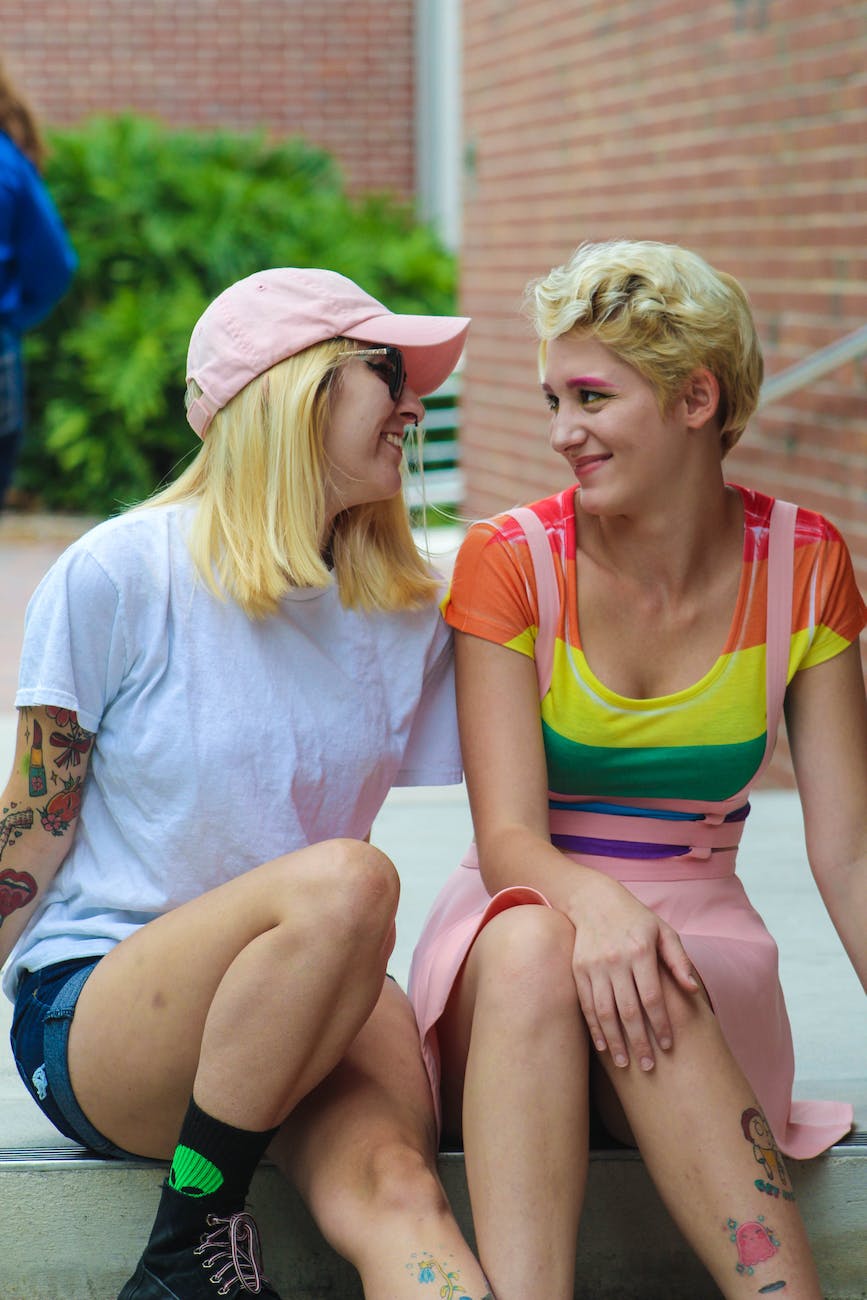 two women sitting while talking each other