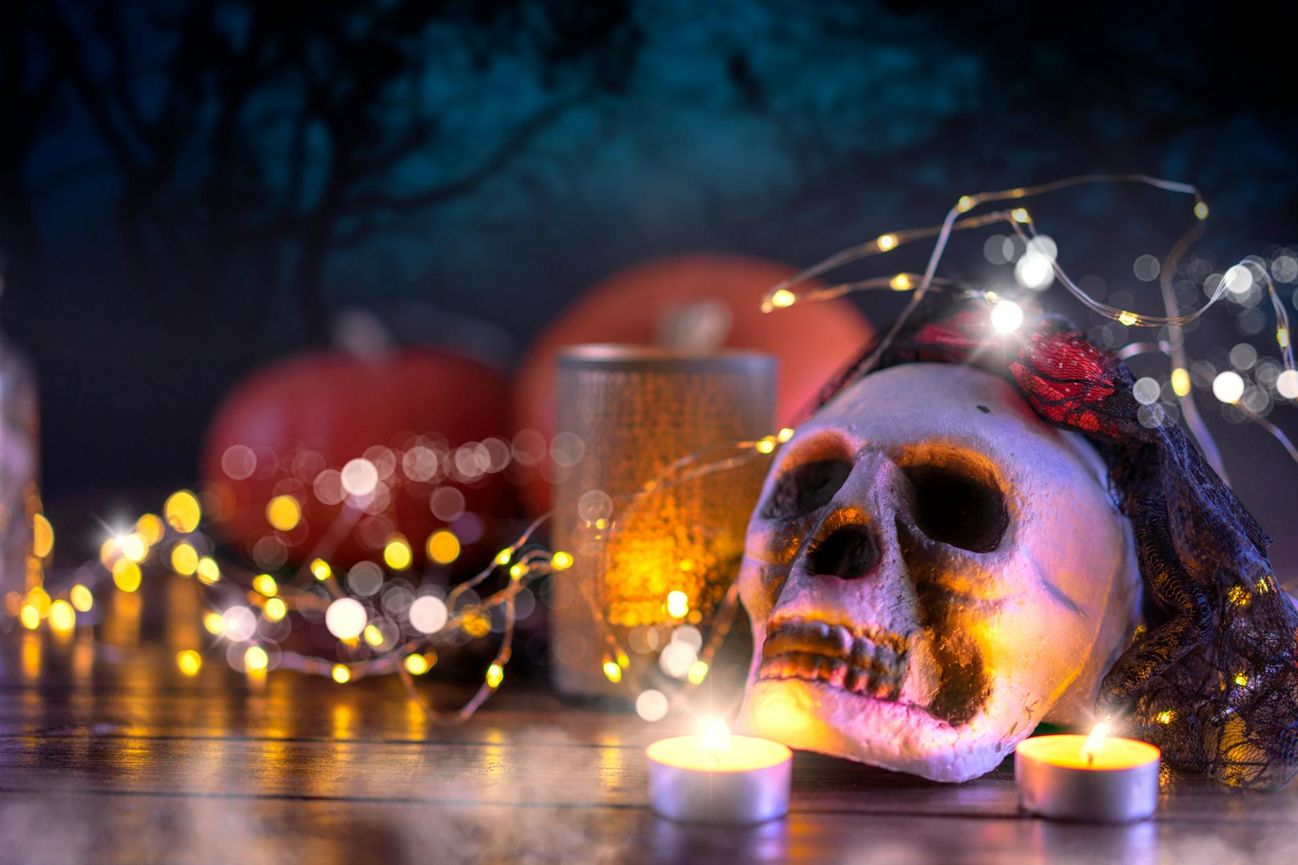 skull and pumpkins with halloween lights