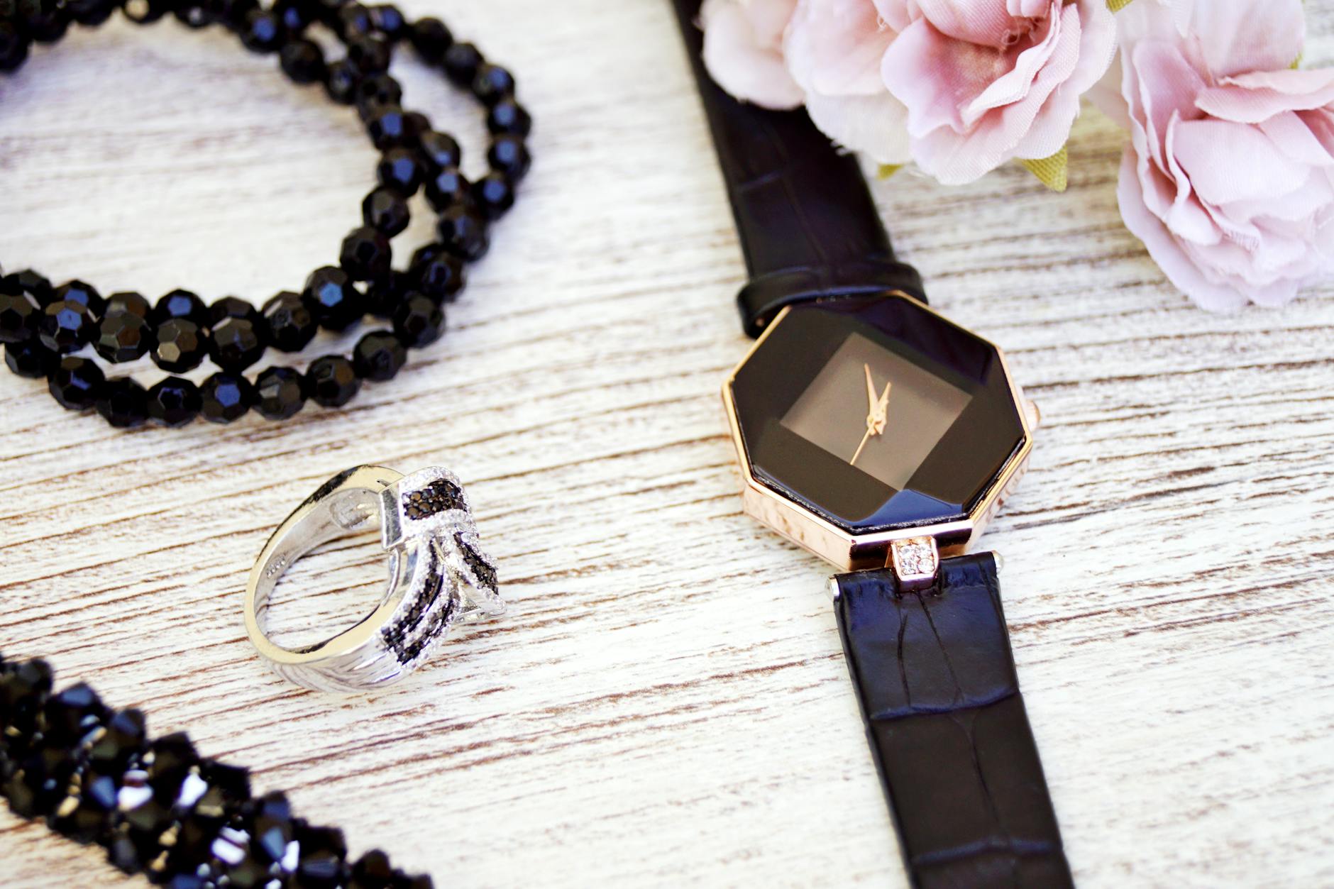 black and gold colored analog watch with leather strap