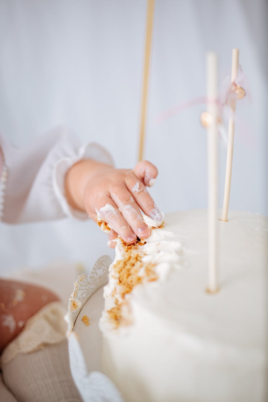 baby hand on birthday cake