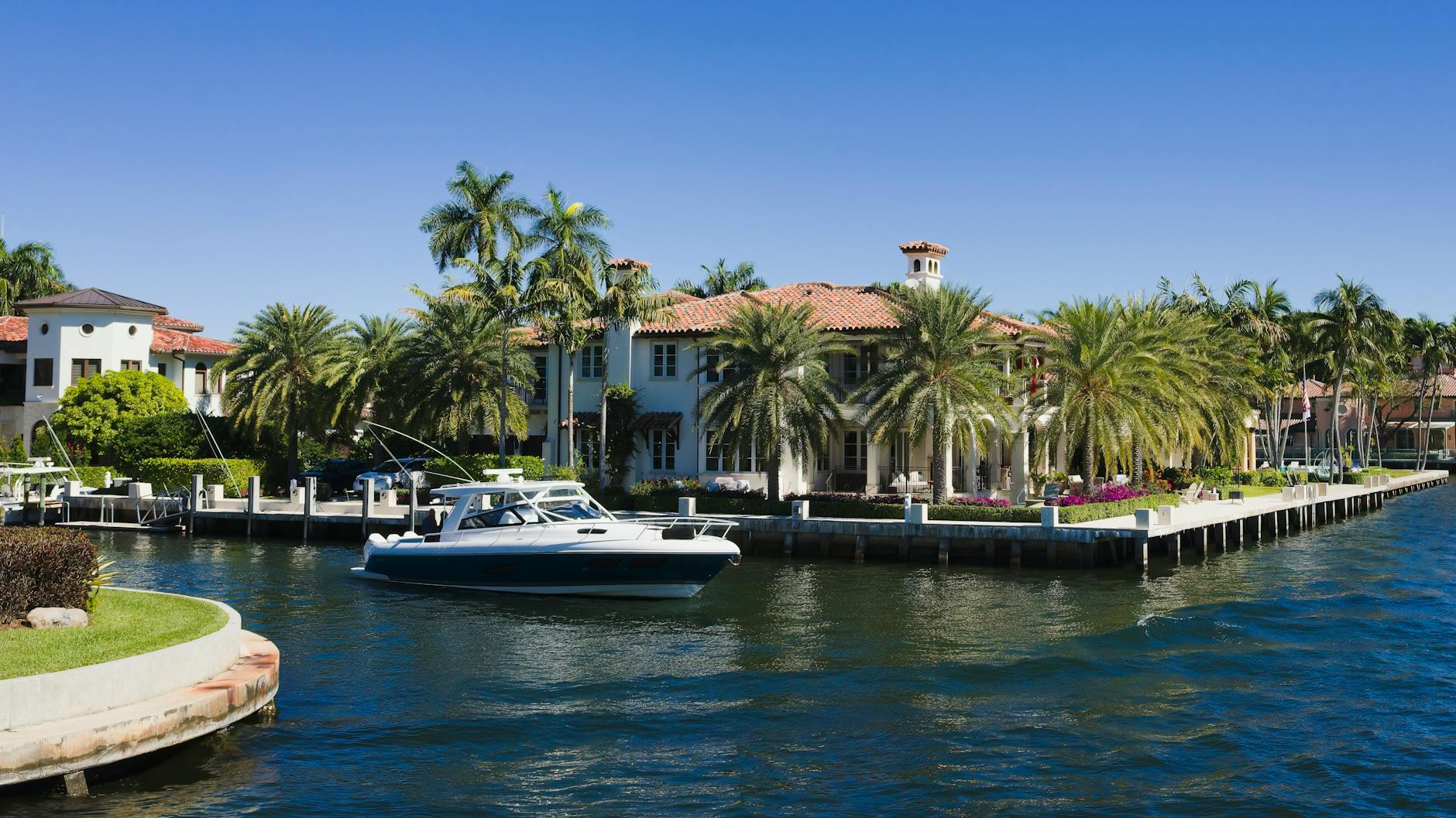 view of boats on a river near the palm trees and mansions in fort lauderdale florida usa