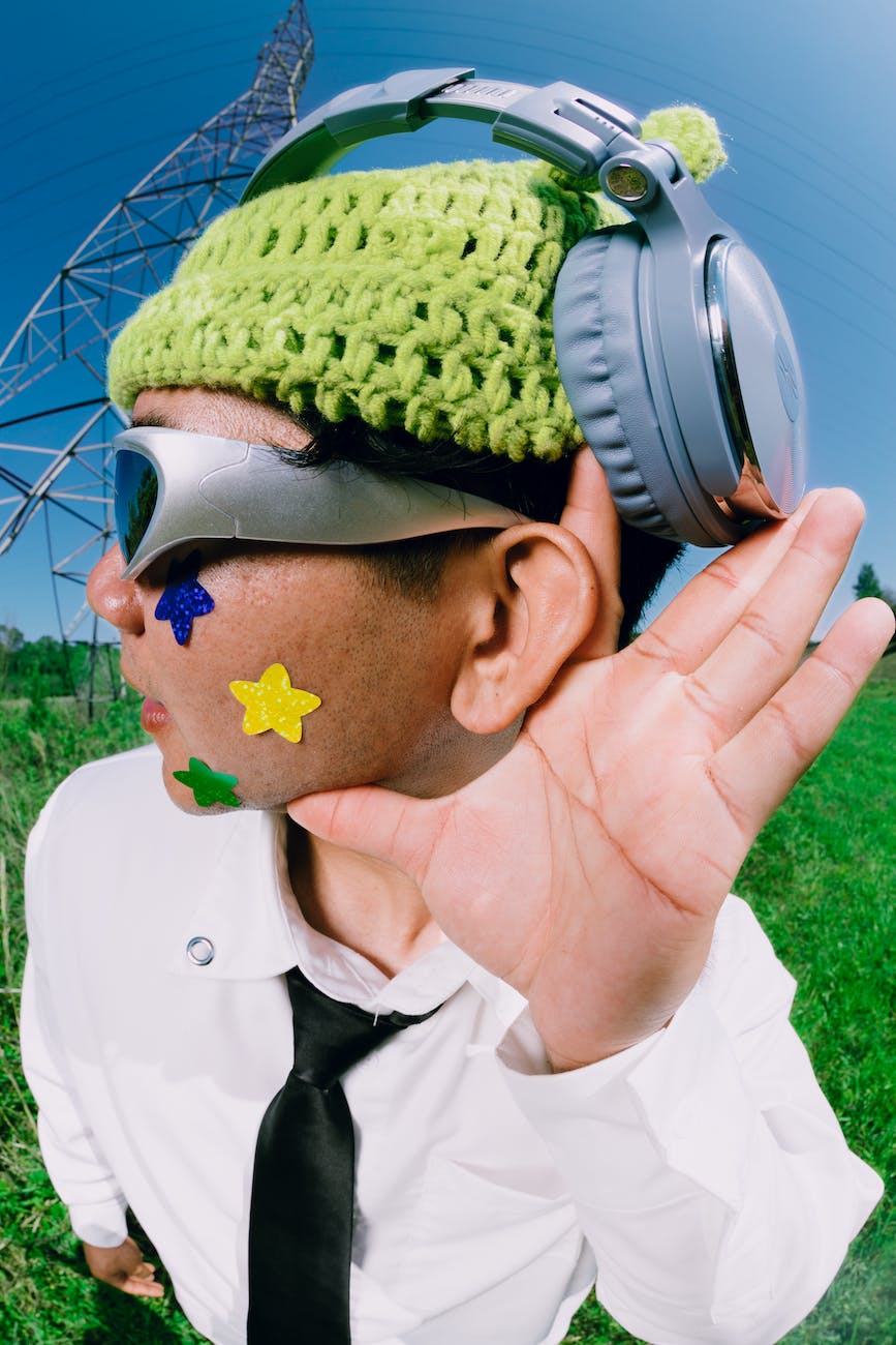 funky man with headphones making hearing gesture