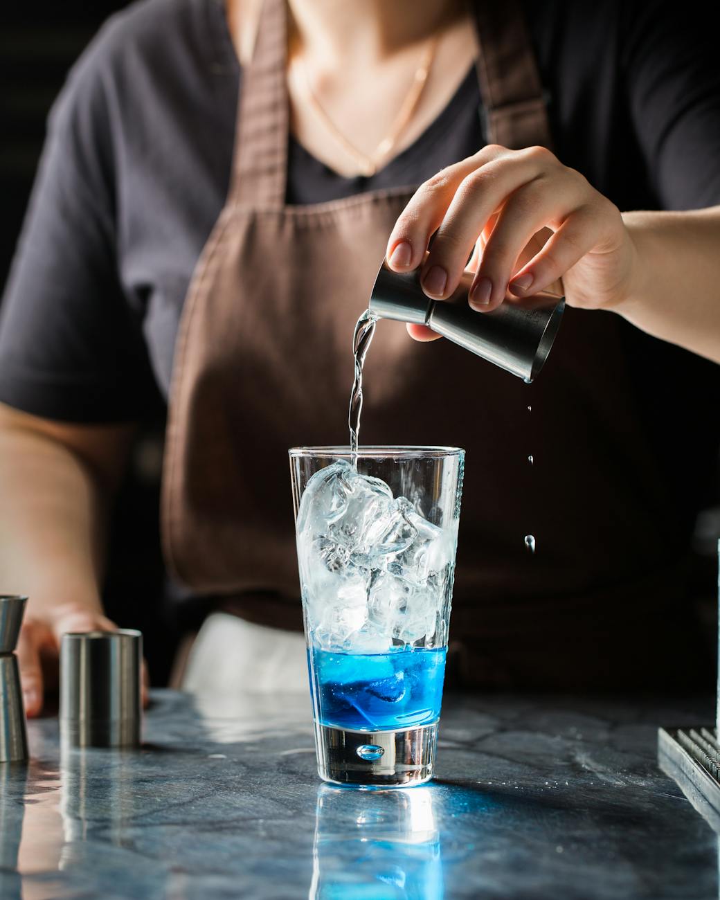 person mixing drinks on cup