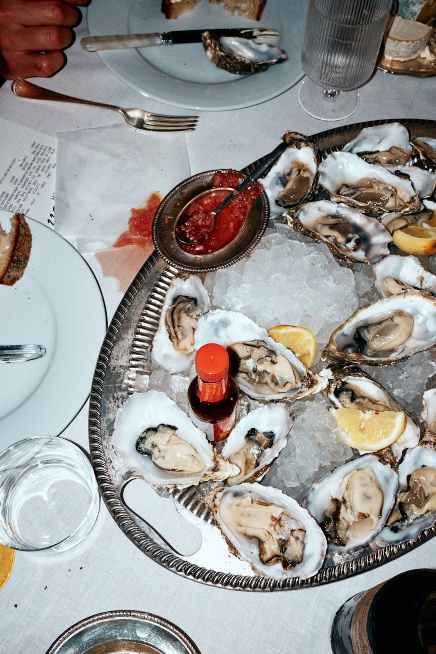 fresh oysters on ice with lemon and sauce