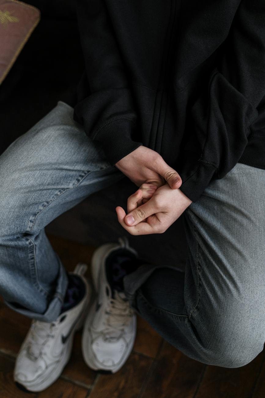 person in black jacket and gray denim jeans
