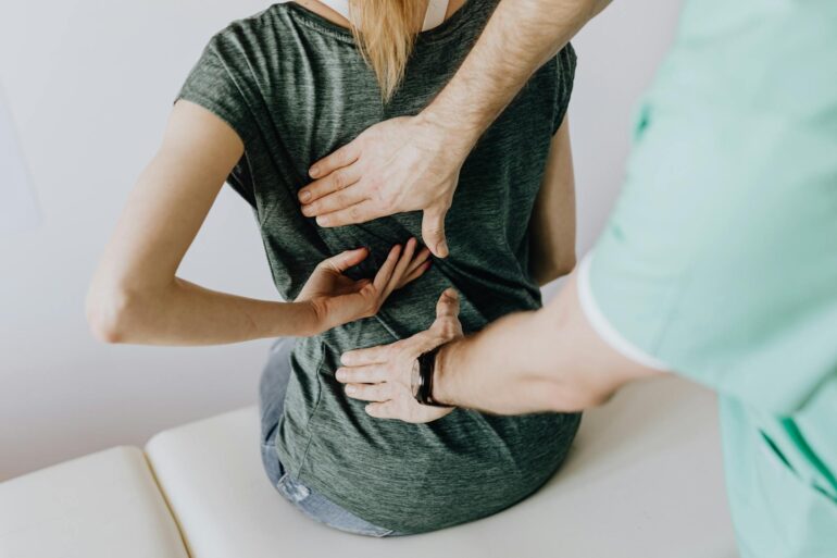 doctor examines woman s back