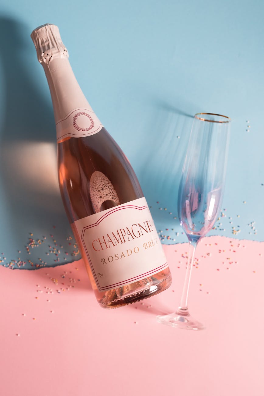 bottle of champagne beside a champagne glass