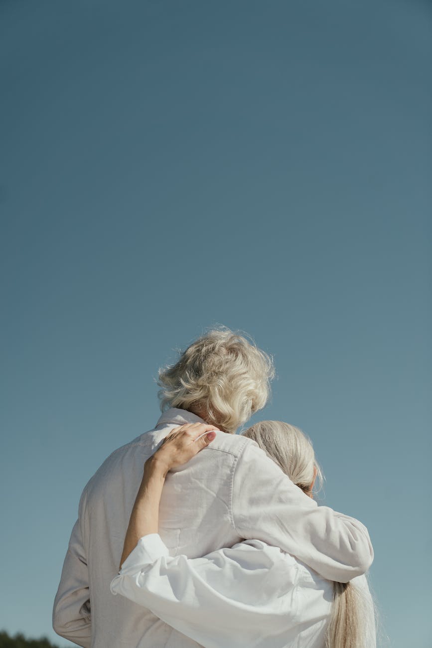 an elderly couple hugging