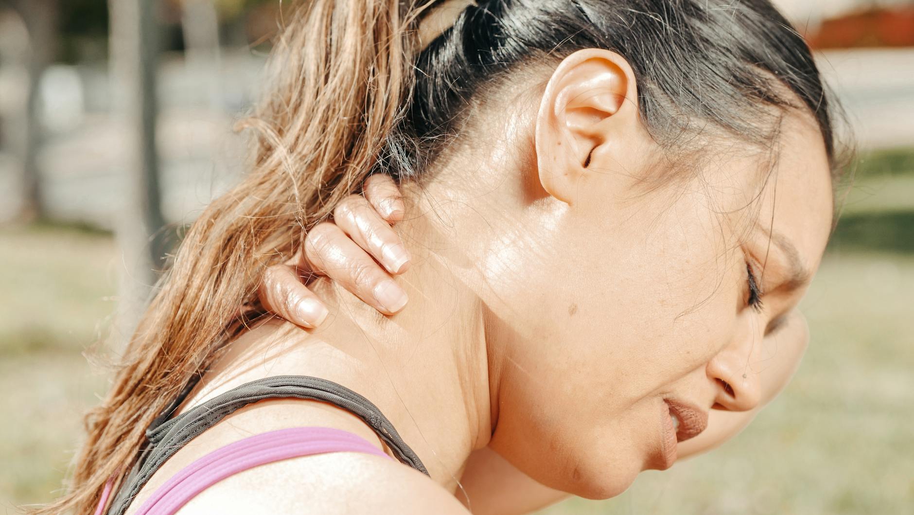 close up photo of woman having a neck pain