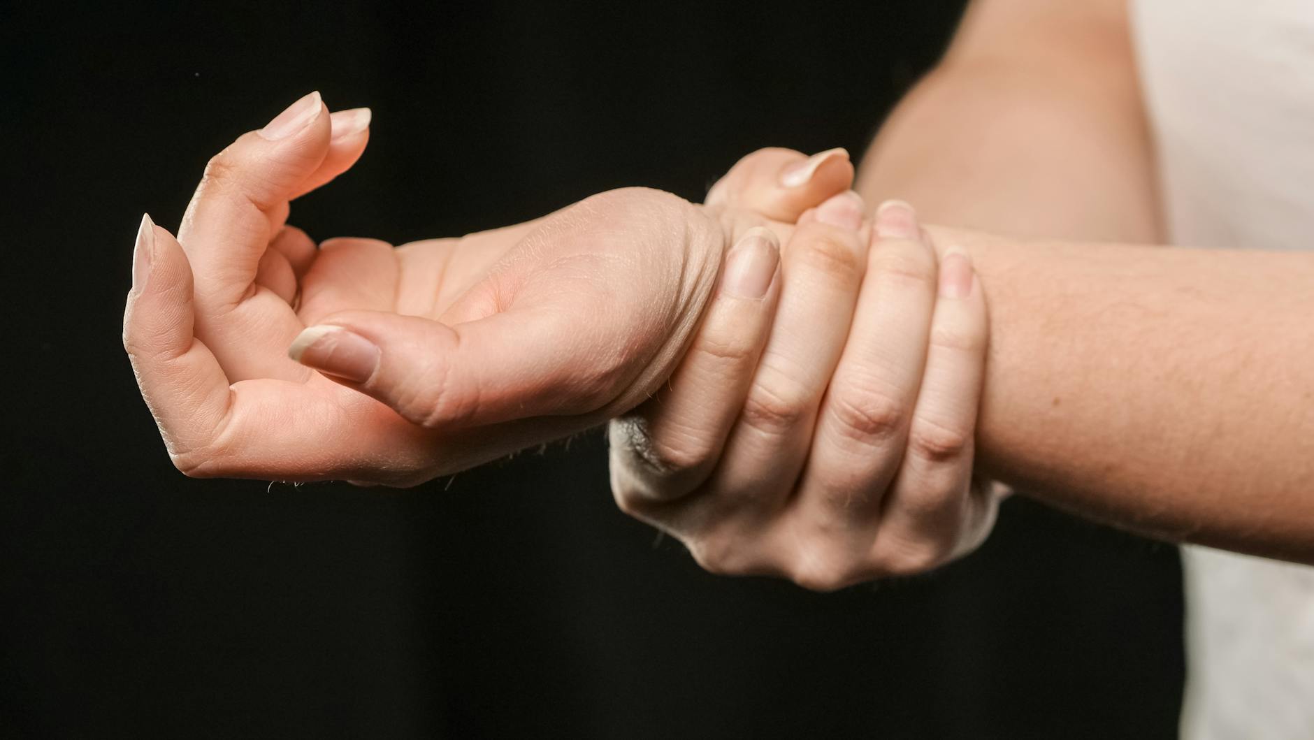 a close up shot of a woman holding her wrist
