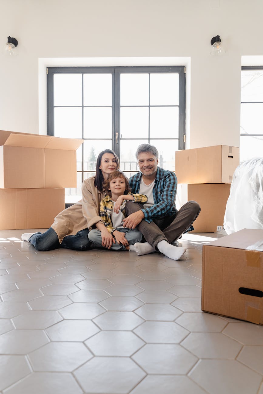 people sitting on the floor with big boxes surrounding them