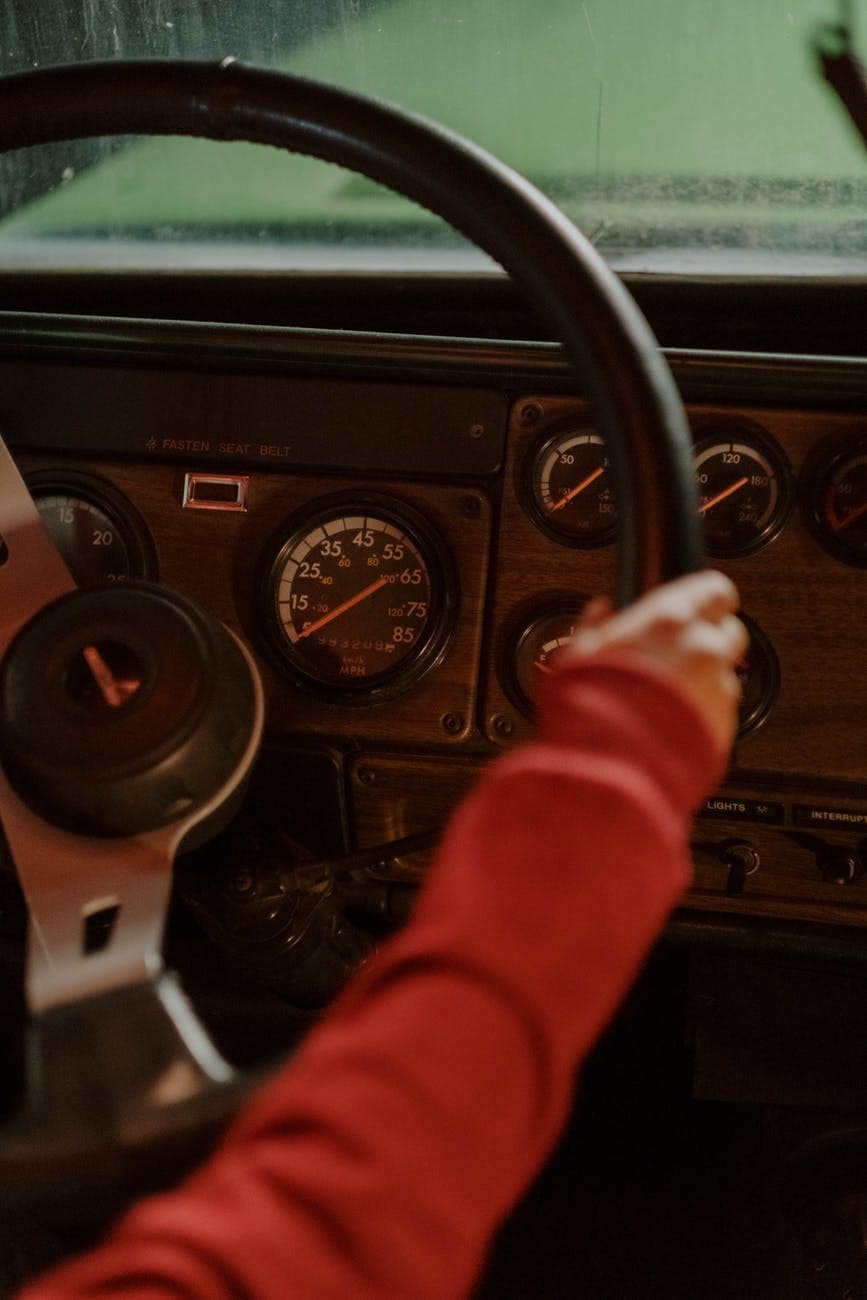 person in red long sleeve shirt driving car