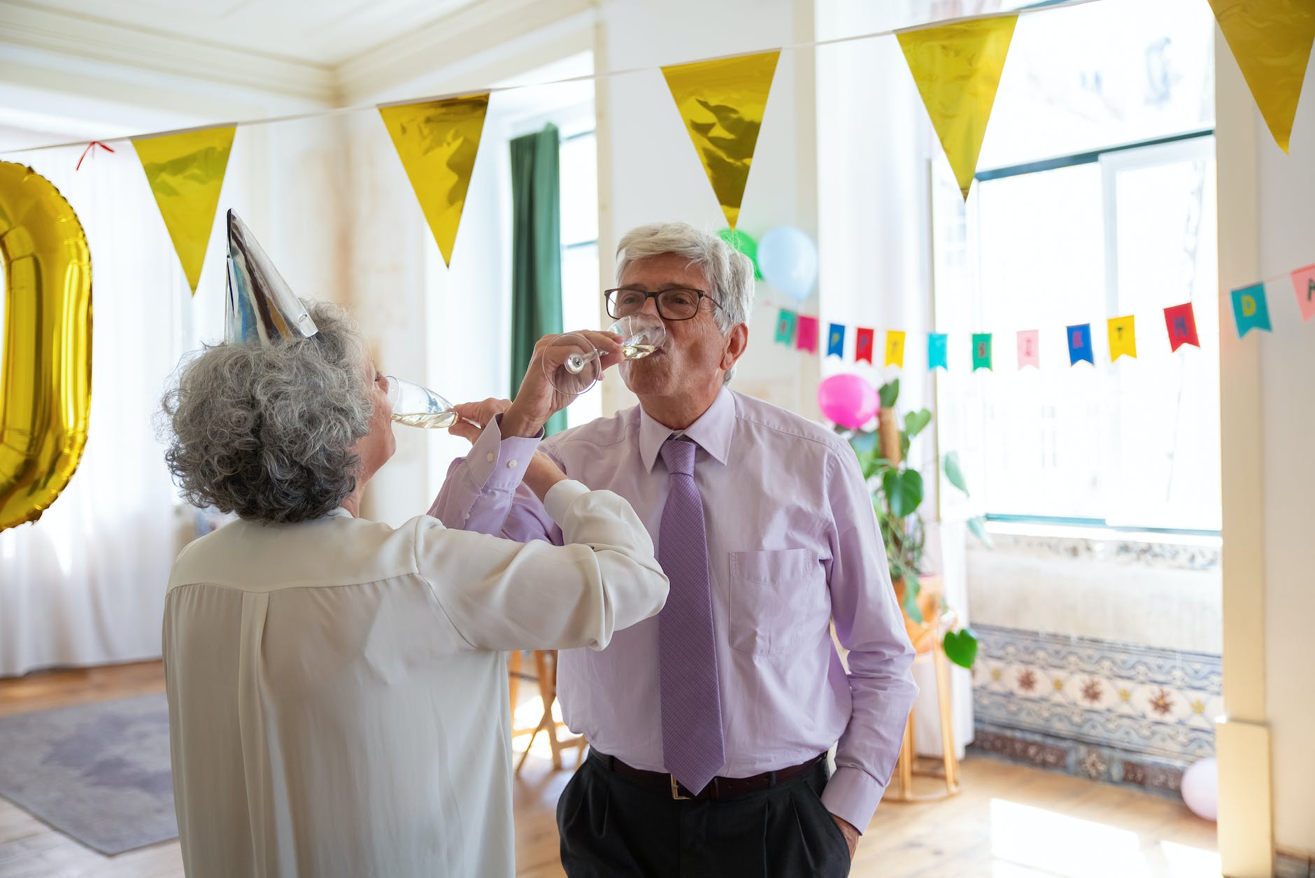 elderly couple drinking champagne together