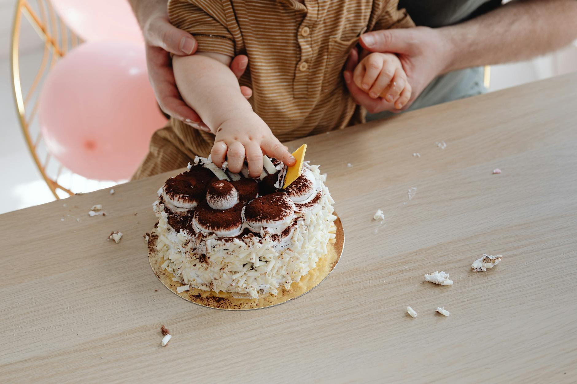 a baby touching the cake