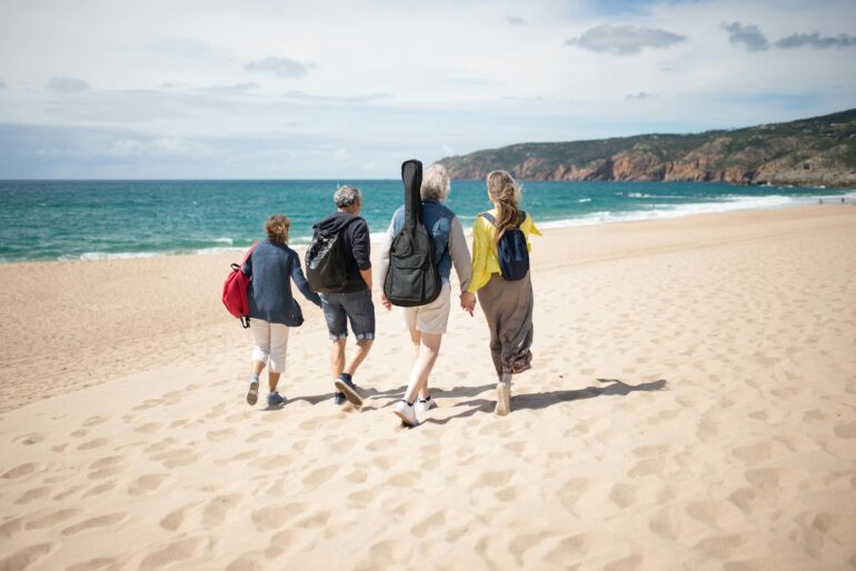 a people walking together on the beach