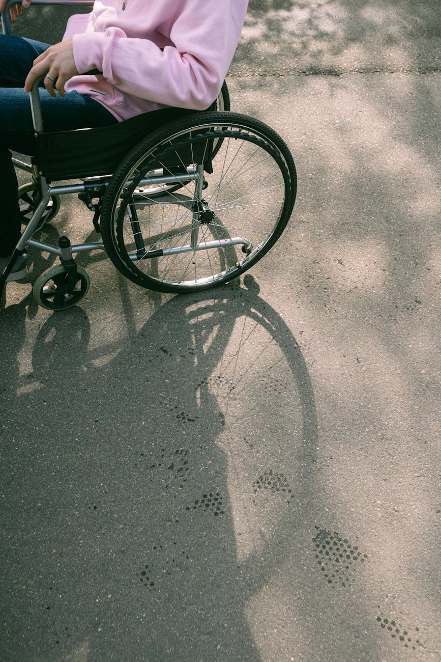 person sitting in a wheelchair and the shadow of it