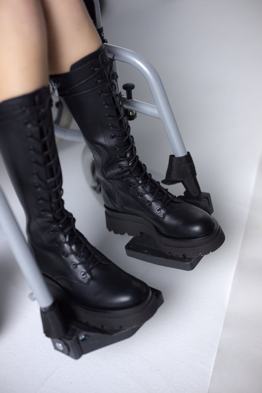person wearing black leather boots sitting on wheelchair